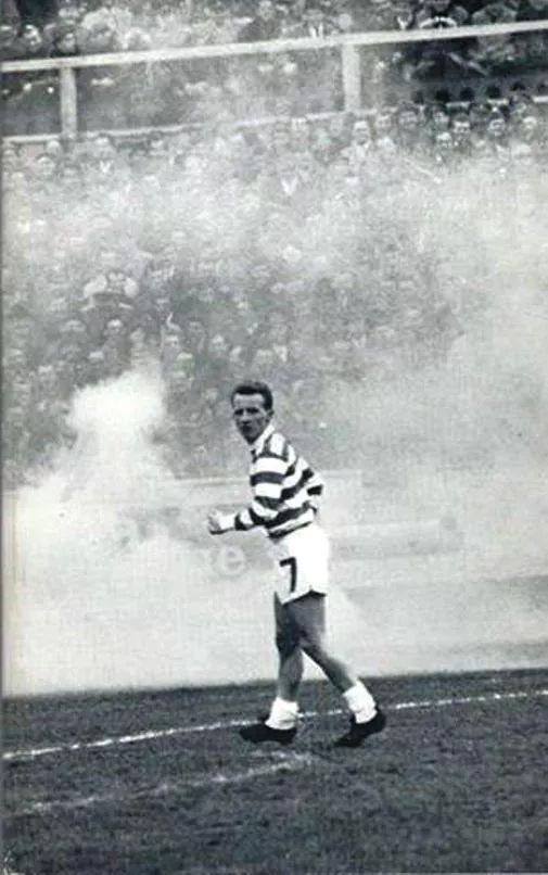 Jinky, smoke flares in the background